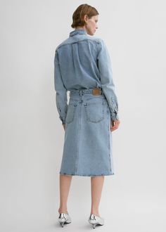 TOTEME skirt designed to sit low on the waist and graze the knees with a subtle A-line shape. It is made in Italy from organic-cotton denim in our seasonal cool blue stonewash and finished with classic belt loops, five pockets and a zipper fly. Complete a head-to-toe denim look with the matching shirt. Workwear Denim Blue Skirt With Belt Loops, Denim Skirt With Belt Loops For Fall, Denim Skirt With Belt Loops For Work, Relaxed Denim Skirt For Work, Spring Denim Skirt With Belt Loops In Straight Shape, Medium Wash Relaxed Denim Skirt For Work, Medium Wash Relaxed Workwear Denim Skirt, Relaxed Fit Denim Skirt In Medium Wash For Work, Relaxed Fit Medium Wash Denim Skirt For Work