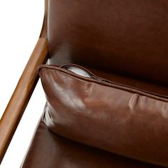 a brown leather reclining chair with a pillow on it's back and wooden armrests