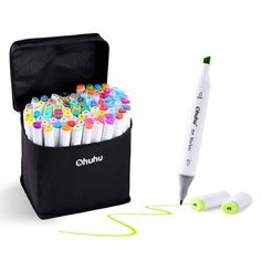 an open case with markers and pens in it next to a pen holder filled with markers