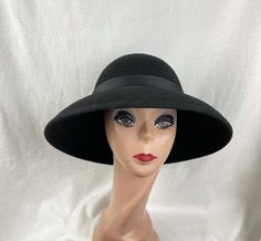 This classic black wool felt lampshade hat has a 4 1/2 inch brim all around. The hat will fit up to a 22- 22 1/2  inch head size. The black grosgrain ribbon is removable if you would like to put another band on. NOTE: Please check the head size before purchase, I am happy to answer any questions you may have. There will be a 20% restocking fee for all returned hats. Cheap Black Hats For Gifts, Luxury Black Felt Hat For Formal Occasions, Luxury Black Felt Hat, Cheap Black Wide Brim Felt Hat, Luxury Black Hats For Cold Weather, Cheap Black Casual Felt Hat, Luxury Black Short Brim Hat, Cheap Playful Black Hats, Playful Cheap Black Hats