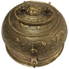 an antique brass box with ornate designs on the lid