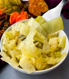 a white bowl filled with chopped cabbage