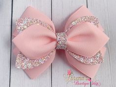 a pink bow with lots of glitter on it