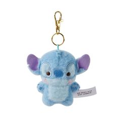 a blue stuffed animal keychain with an ear tag on it's side