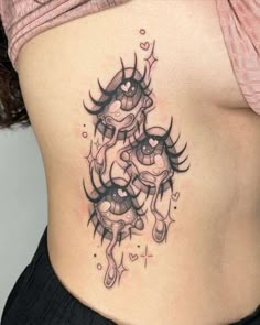 a woman's stomach with an artistic tattoo design on her belly and the bottom