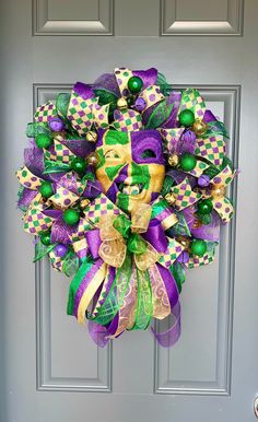 a purple and green wreath on the front door with st patrick's day decorations