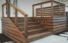 a wooden stair case next to a white house