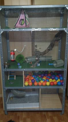 a large metal shelf filled with lots of balls and other items on top of it