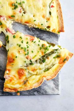 a cheesy quiche with asparagus and cheese is cut into slices