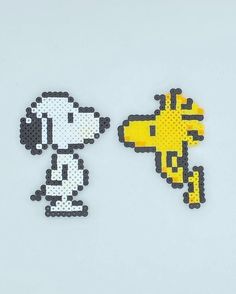 two pieces of perler bead art depicting a dog and a giraffe