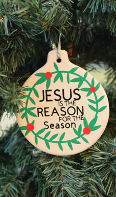 jesus is the reason for the season ornament hanging on a christmas tree branch