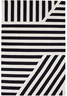 a black and white rug with stripes on the bottom, diagonals in different colors