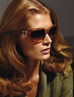 a woman with long hair wearing sunglasses