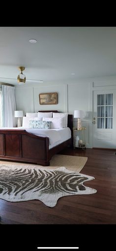 a bedroom with a zebra rug on the floor