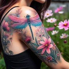 a woman's arm with flowers and a dragonfly tattoo on her left shoulder