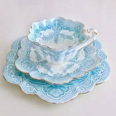 three blue and white dishes stacked on top of each other