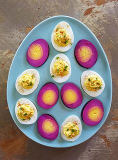 an overhead view of deviled eggs on a blue plate