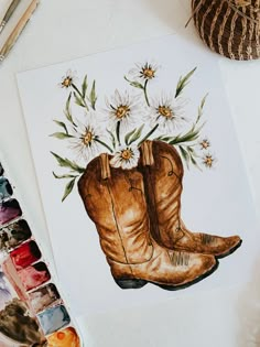 a watercolor painting of a pair of boots with daisies in them on a table