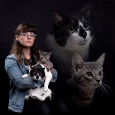 a woman holding two cats in front of her and three other cats looking at the camera