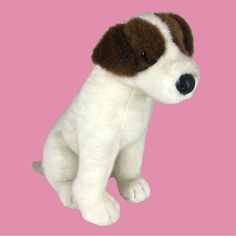 a stuffed dog sitting on top of a pink background