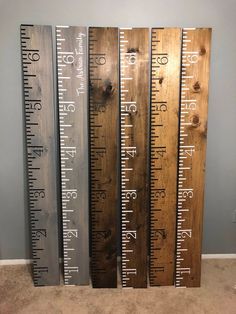 three wooden rulers are lined up against the wall