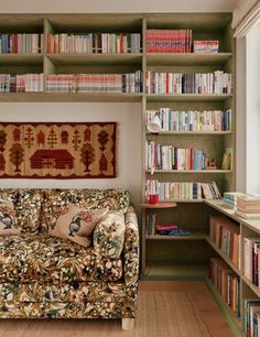 a living room filled with furniture and lots of bookshelves full of different types of books