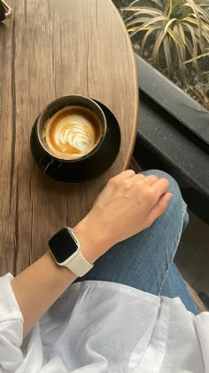 a person sitting at a table with an apple watch on their wrist