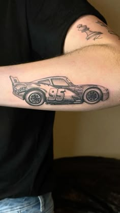 a man with a car tattoo on his arm