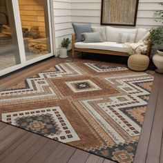 an outdoor area rug is on the wooden deck