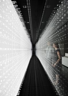 an image of a man standing in the middle of a room with many lights on it