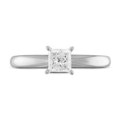 a princess cut diamond ring on a white background