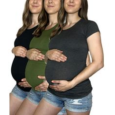 three pregnant women standing next to each other with their hands on their stomachs,