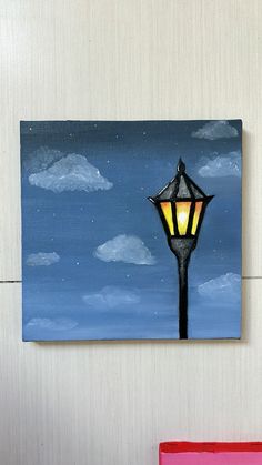 a painting of a street light on a wall