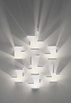 the light is shining through the ceiling in the room with many square lights on it