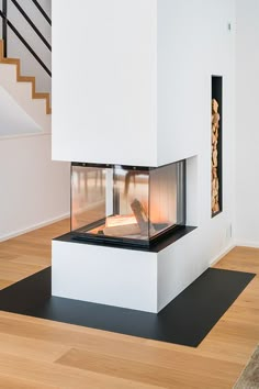 a white fireplace in the middle of a room