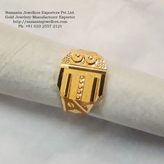 a gold ring sitting on top of a napkin