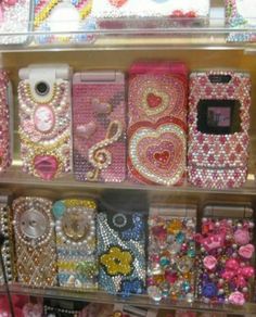 a display case filled with lots of different types of cell phones covered in swaroons