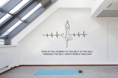 there is a yoga mat on the floor in front of a wall that says yoga as the journey of the see it to the self through the self