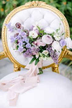 a bouquet of flowers sitting on top of a white chair