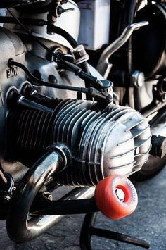 the front end of a motorcycle with a red ball on it