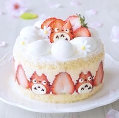 there is a cake decorated with strawberries on the plate