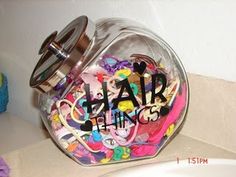 a jar filled with lots of colorful confetti on top of a bathroom counter