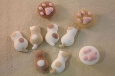 there are several cookies shaped like animals on the floor with paws and feet painted on them