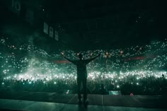 a man standing in front of a crowd at a concert