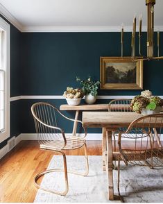 a dining room with blue walls and wooden floors