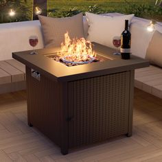 a fire pit sitting on top of a wooden floor next to a bottle of wine