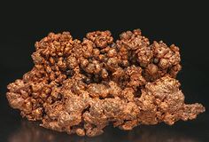 a cluster of brown rocks sitting on top of a black table next to each other