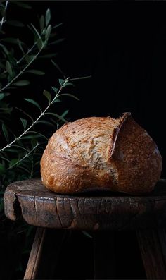 a loaf of bread sitting on top of a wooden stool