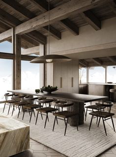 a dining room with tables and chairs in the middle of an open floor plan area