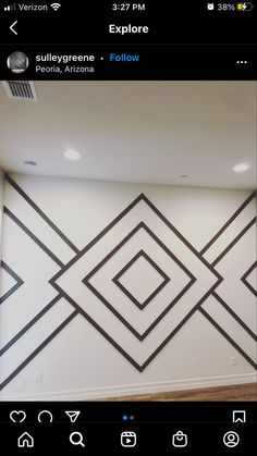 the wall is decorated with black and white geometric designs, which appear to be in an empty room